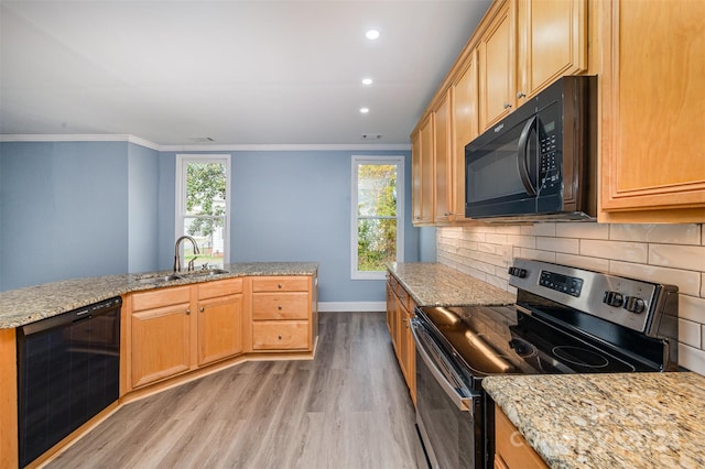 kitchen featuring sink, black appliances, crown molding, and light hardwood / wood-style flooring