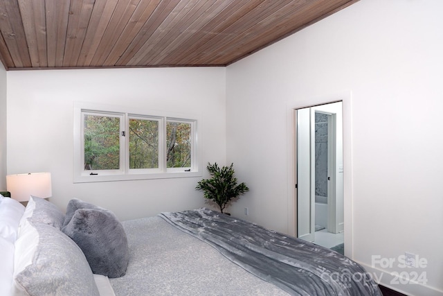 bedroom with wood ceiling, ensuite bathroom, carpet, and lofted ceiling