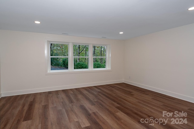 spare room with dark hardwood / wood-style flooring