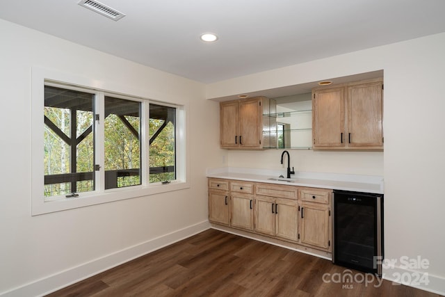 kitchen featuring wine cooler, dark hardwood / wood-style flooring, and sink