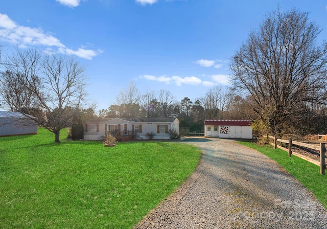 single story home with an outbuilding and a front yard