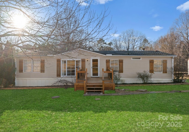 rear view of house with a yard and a deck