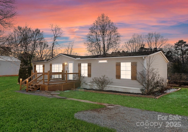 view of front of house featuring a yard and a deck