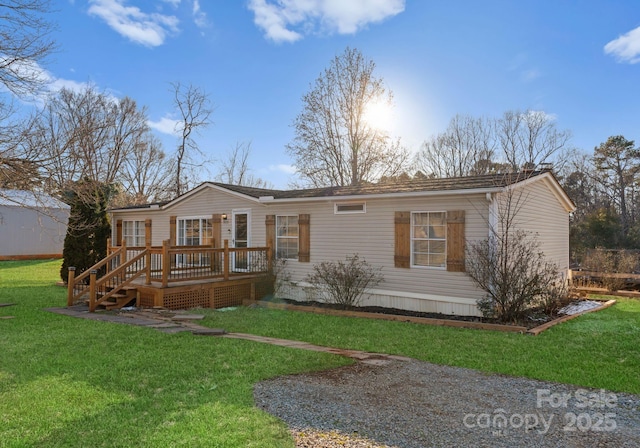 view of front of property featuring a front lawn and a deck