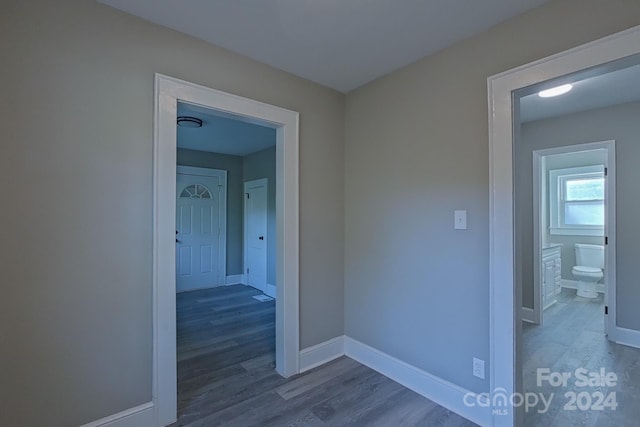 hall with hardwood / wood-style flooring