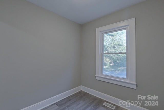 spare room with hardwood / wood-style floors