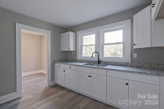 kitchen featuring sink, white cabinets, and light hardwood / wood-style floors