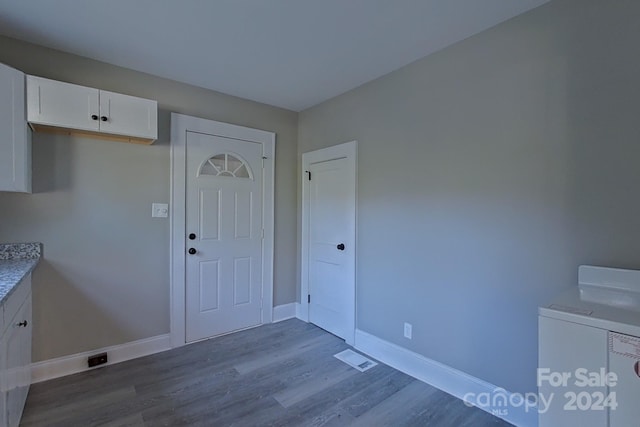 clothes washing area featuring hardwood / wood-style flooring