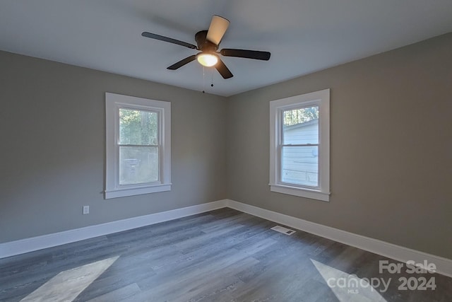 empty room featuring ceiling fan and dark hardwood / wood-style floors