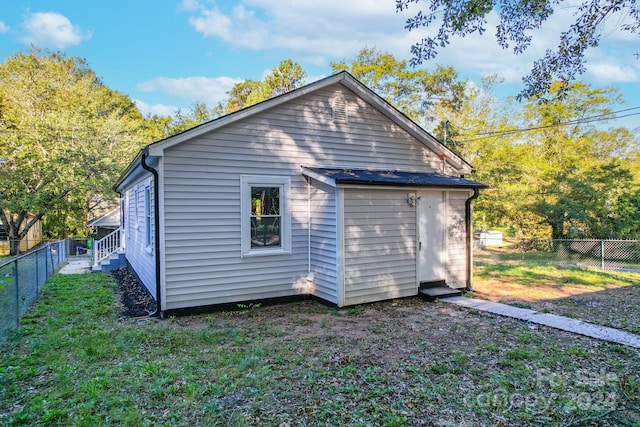 back of property featuring a yard