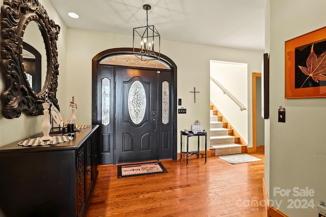 entryway with a notable chandelier and hardwood / wood-style flooring