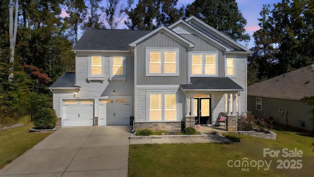 craftsman-style house featuring a garage, a yard, and covered porch