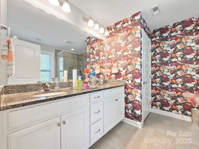 bathroom with vanity, an enclosed shower, and tile patterned floors