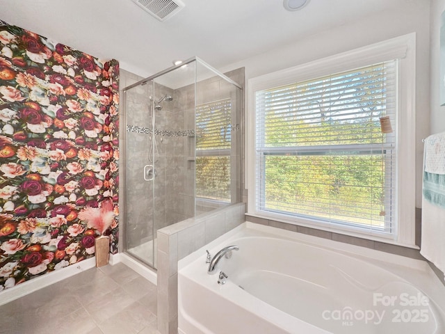 bathroom featuring shower with separate bathtub