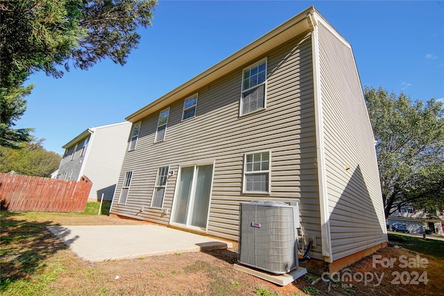 rear view of house with cooling unit and a patio