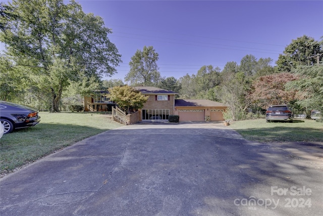 view of front of property with a front yard and a garage