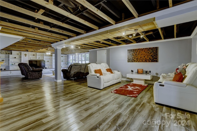 living room featuring ceiling fan, decorative columns, and hardwood / wood-style floors