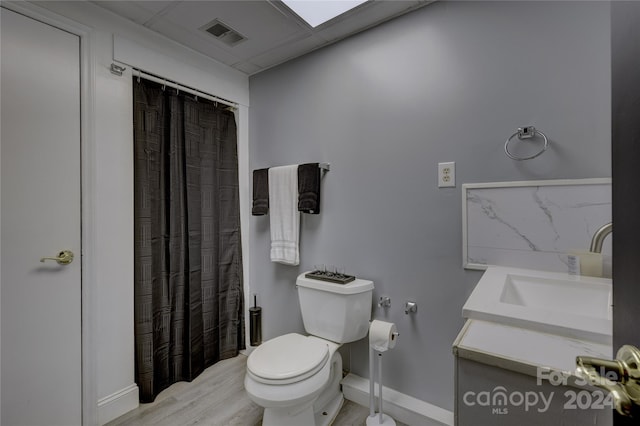 bathroom featuring vanity, toilet, and hardwood / wood-style floors