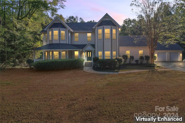 victorian home featuring a garage and an outdoor structure