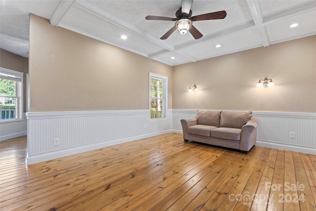 sitting room with beam ceiling, ceiling fan, coffered ceiling, and light hardwood / wood-style flooring