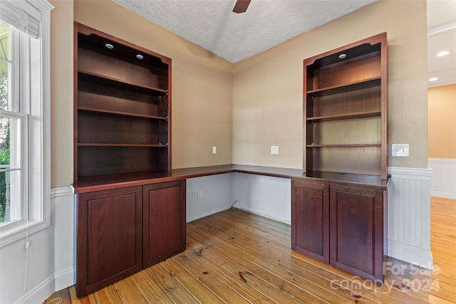 2720 Lentz Rd, China Grove, NC 28023 - unfurnished office featuring a wainscoted wall, a textured ceiling, light wood-type flooring, built in study area, and ceiling fan