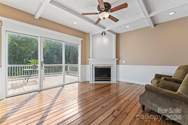 2720 Lentz Rd, China Grove, NC 28023 - living area featuring hardwood / wood-style flooring, ceiling fan, a wainscoted wall, beamed ceiling, and coffered ceiling