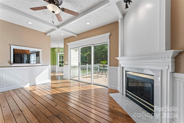 2720 Lentz Rd, China Grove, NC 28023 - unfurnished living room with hardwood / wood-style floors, ceiling fan with notable chandelier, a wainscoted wall, a fireplace, and beam ceiling