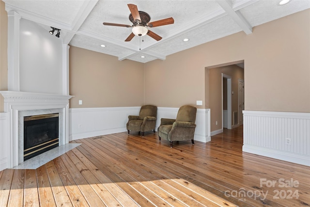 unfurnished room with coffered ceiling, a textured ceiling, light wood-type flooring, and beam ceiling