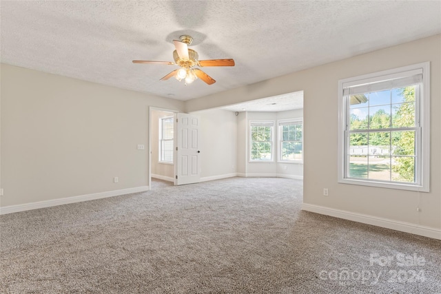 2720 Lentz Rd, China Grove, NC 28023 - empty room featuring baseboards, a ceiling fan, a textured ceiling, and carpet