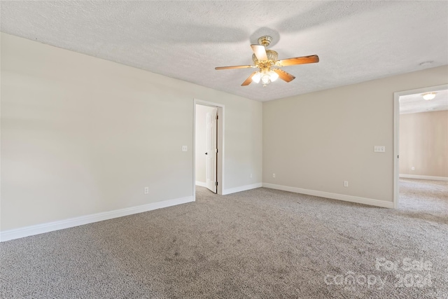 spare room with ceiling fan, carpet floors, and a textured ceiling