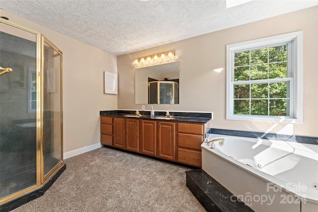 bathroom featuring shower with separate bathtub, vanity, and a textured ceiling