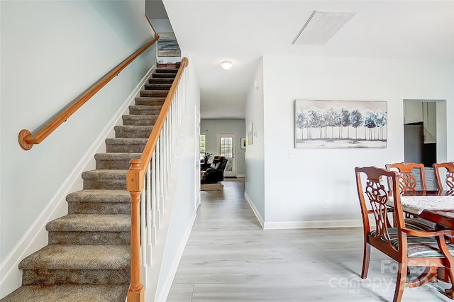 stairway featuring wood-type flooring