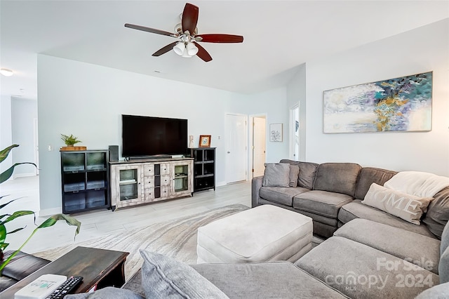 living room featuring ceiling fan and light wood-type flooring