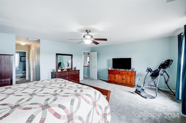 carpeted bedroom featuring ceiling fan and ensuite bath