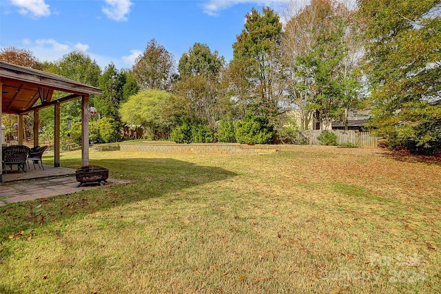 view of yard with a patio and a fire pit