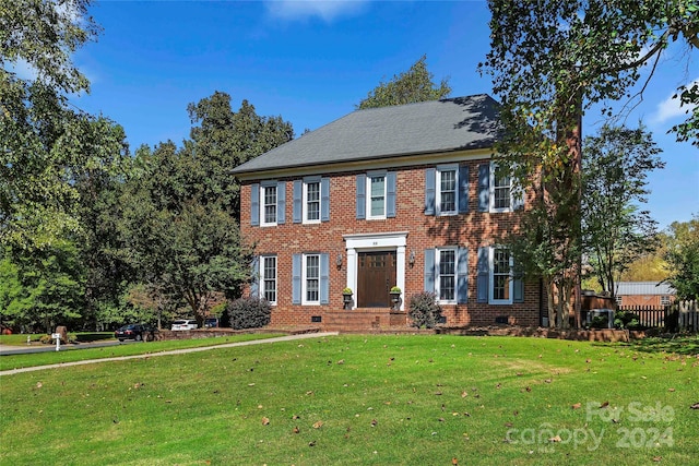 colonial home featuring a front yard