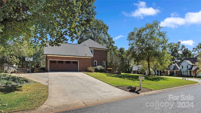 front of property with a front yard and a garage