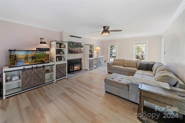 living room with light hardwood / wood-style floors, crown molding, and ceiling fan