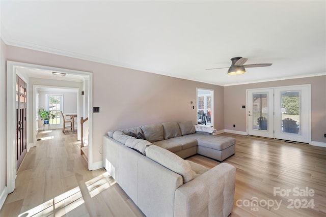 living room featuring ornamental molding, a healthy amount of sunlight, ceiling fan, and light hardwood / wood-style floors