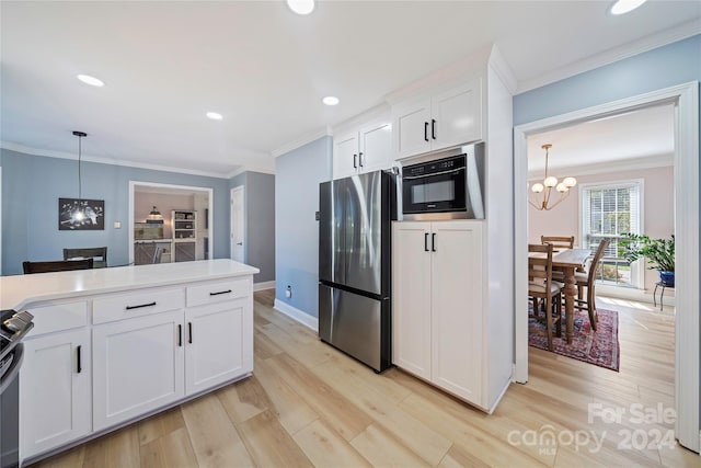 kitchen with pendant lighting, light hardwood / wood-style floors, appliances with stainless steel finishes, and white cabinetry