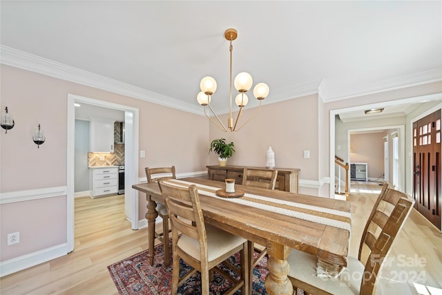 dining space with ornamental molding, light hardwood / wood-style floors, and a chandelier