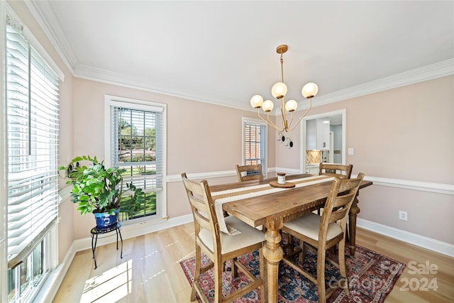 dining area featuring a notable chandelier, light hardwood / wood-style flooring, and crown molding