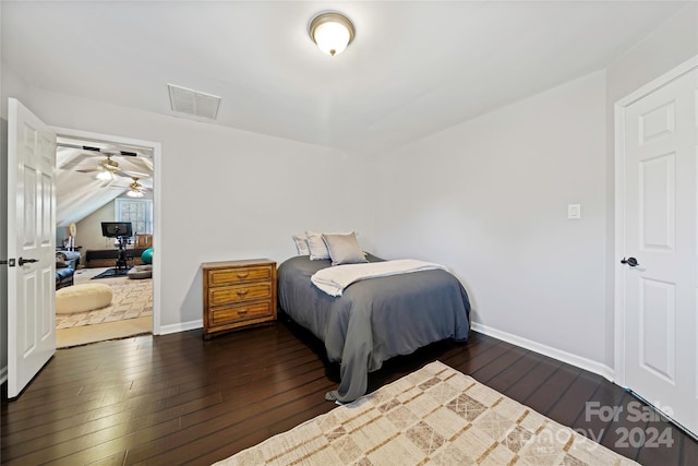 bedroom with dark hardwood / wood-style flooring