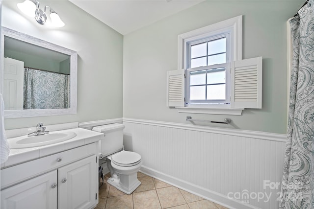 bathroom featuring vanity, toilet, and tile patterned floors