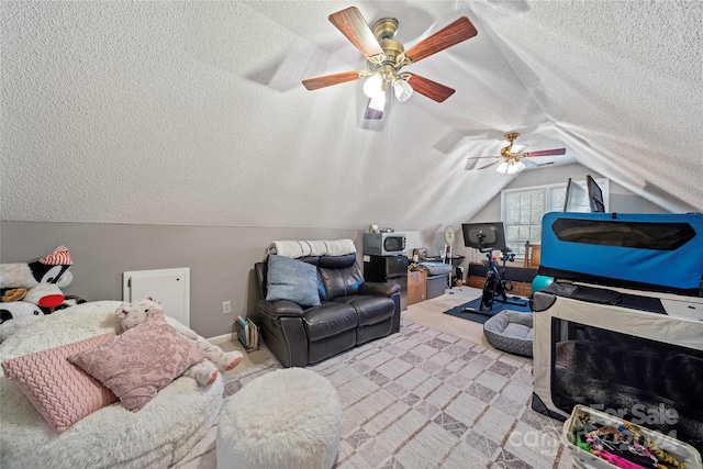 bedroom with lofted ceiling, a textured ceiling, and ceiling fan