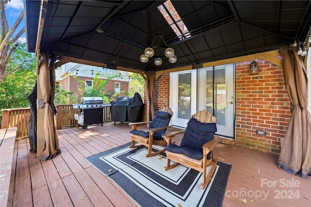 wooden terrace featuring a gazebo and area for grilling