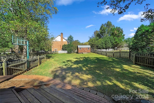 view of yard featuring a storage unit and a deck