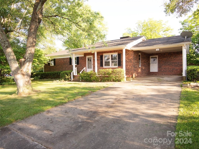 ranch-style house with a front lawn and a carport