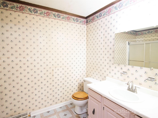 bathroom with a textured ceiling, walk in shower, vanity, and toilet