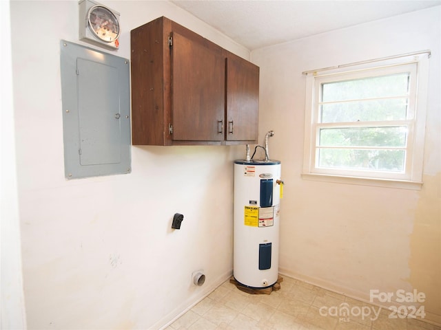 laundry area featuring cabinets, water heater, electric panel, and electric dryer hookup